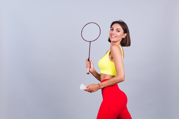 Fit woman in sportswear top and leggings hold badminton racket happy positive cheerful