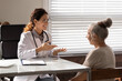 Smiling young Caucasian female doctor talk consult mature woman patient in hospital clinic. Happy nurse or GP have consultation with old middle-aged client. Healthcare, elderly medicine concept.