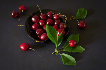 Ripe red cherries on a dark background