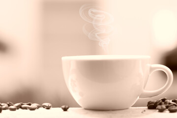 Poster - Coffee cup and coffee beans on table, americano coffee in coffee shop, copy space for text, close up white cup on counter