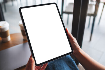 Mockup image of a woman holding digital tablet with blank white desktop screen