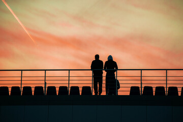 two men watch the sunset