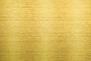 Shiny gold polished metal background texture of brushed stainless steel plate with the reflection of light.