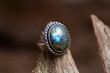 Brass metal labradorite mineral stone ring on natural background