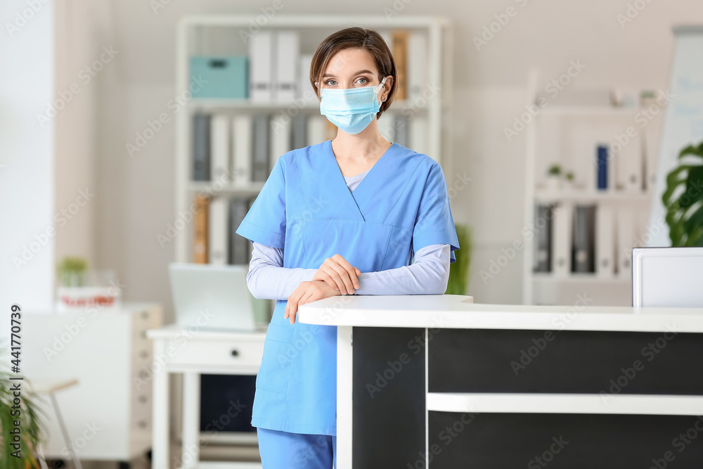 Female receptionist at desk in clinic