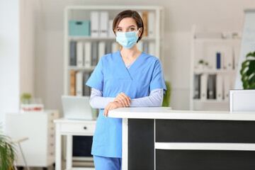 Canvas Print - Female receptionist at desk in clinic