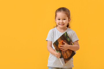 Poster - Cute little girl with book on color background