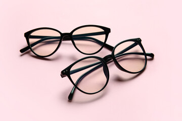 Different stylish eyeglasses on color background