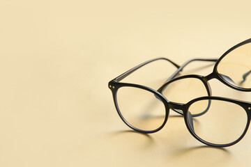 Different stylish eyeglasses on color background, closeup