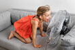 © Lisa Tichané - Silly young girl screaming in front of a fan
