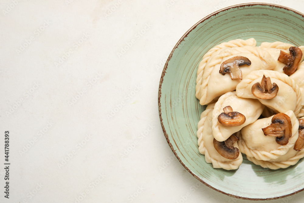 Plate with tasty dumplings on white background