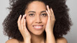 © fizkes - Close up portrait of smiling young African American woman with healthy glowing facial skin after salon procedures. Happy mixed race female touch face, good cosmetology treatment. Skincare concept.