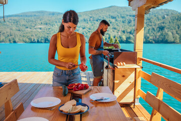 Lovely couple making breakfast outdoors