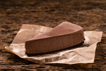 Sticker - Slice of chocolate Cheesecake, healthy organic summer dessert cheesecake on wooden table background