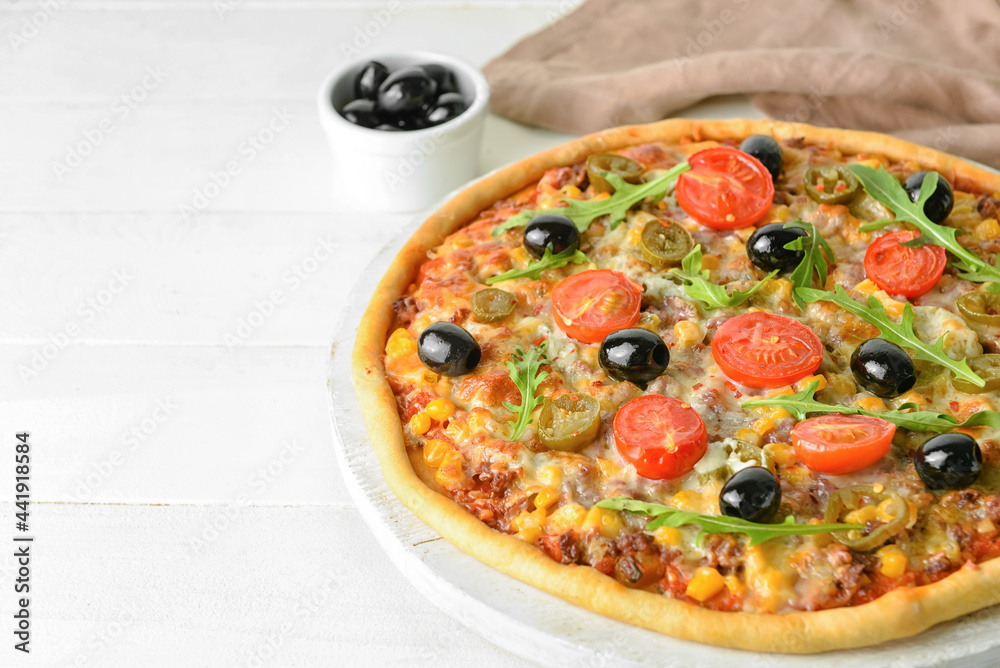 Board with tasty pizza on light wooden background, closeup