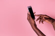 © ADDICTIVE STOCK - Hands of black man holding phone with blank screen