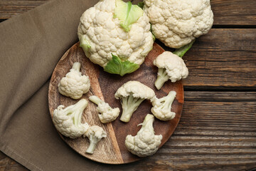 Plate with cauliflower cabbages on wooden background