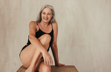 Smiling Mature Woman Embracing Her Aging Body