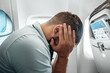 A man sits in front of an airplane window and is nervous, afraid to fly, the cabin of a passenger aircraft. Aerophobia, fobilya, international flights.