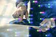 © peshkova - Double exposure of man's hand holding and using a digital device and data theme hologram drawing. Technology concept.