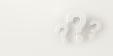 Three Question Marks In Panoramic White Studio Background.