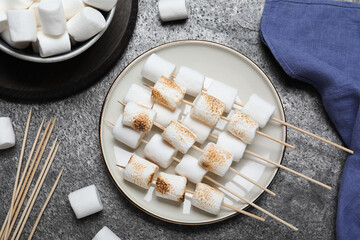 Sticker - Sticks with roasted marshmallows on grey table, flat lay