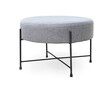 Upholstered round gray footstool