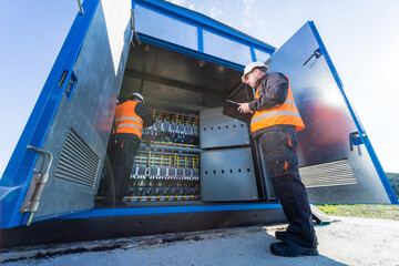 Wall Mural - checking the operating voltage levels of the solar panel switchgear compartment