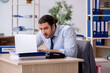 © Elnur - Young male bookkeeper working in the office