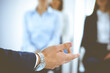 © rogerphoto - Business man making presentation to group of people, close-up. Speaker delivering a seminar to his colleagues or business training in office. Teamwork and coaching concept