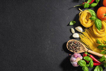 Canvas Print - Ingredients for cooking italian food, pasta, tomatoes, pepper, garlic and parsley on dark background with copy space, top view