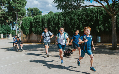 A group of children running to enter the school. Back to school concept