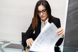 © Minerva Studio - Close up of woman hands doing paperwork at glass desk. Secretary concept