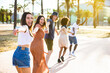 © Xavier Lorenzo - Multiethnic group of young friends running happily together while holding hands - Travel lifestyle concept with multiracial group of millennial tourists having fun in summer