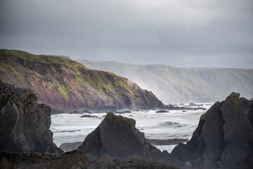 Wall Mural - stunning landscape image of view from hartland quay in devon england durinbg moody spring sunset