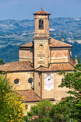 Wall Mural - Narrow road and old brick church in Guarene, Italy.