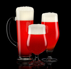 Wall Mural - Set of fresh draft beer glasses with bubble froth isolated on black background.