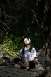 © Марина Ролько - Young woman sitting in a relaxed pose in nature, in the sunlight, yoga