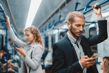 passengers in a subway car standing at a safe distance .