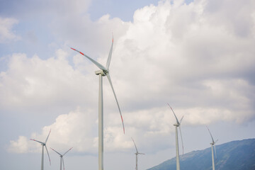 Wind power plant. green meadow with Wind turbines generating electricity