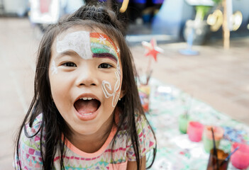 happy asian Child preschooler with face painting. Make up.