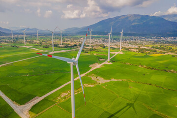 Wind power plant. green meadow with Wind turbines generating electricity