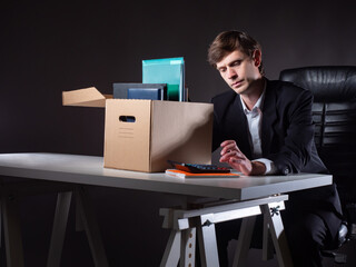 Dismissal man with a calculator in his hands. Concept - he considers employer debt. dismissal manager considers his vacation allowance. Dismissal person calculates compensation from employer.