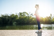 © fotofabrika - Athletic fit young woman jogging early in the morning in park