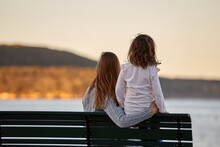 Mother And Daughter Sharing Time Together On Sunset At Beach