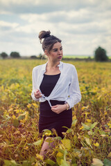 incredibly beautiful young woman posing in a rural field in summer