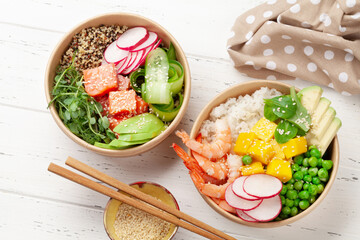 Wall Mural - Poke bowls with shrimps, salmon, avocado and mango