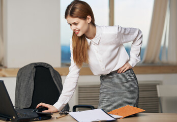 Business woman in office in front of laptop technology professional communication