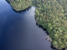 Bird's Eye View Of A Pond, Lake With Green Trees. Aerial, Drone Nature Photography Taken From Above In Sweden In Summer. Dark Blue Water Surface Background With Copy Space And Place For Text.