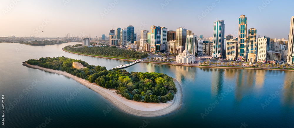 Sharjah aerial panorama above Al Noor island and mosque and downtown rising above Khalid lake - obrazy, fototapety, plakaty 